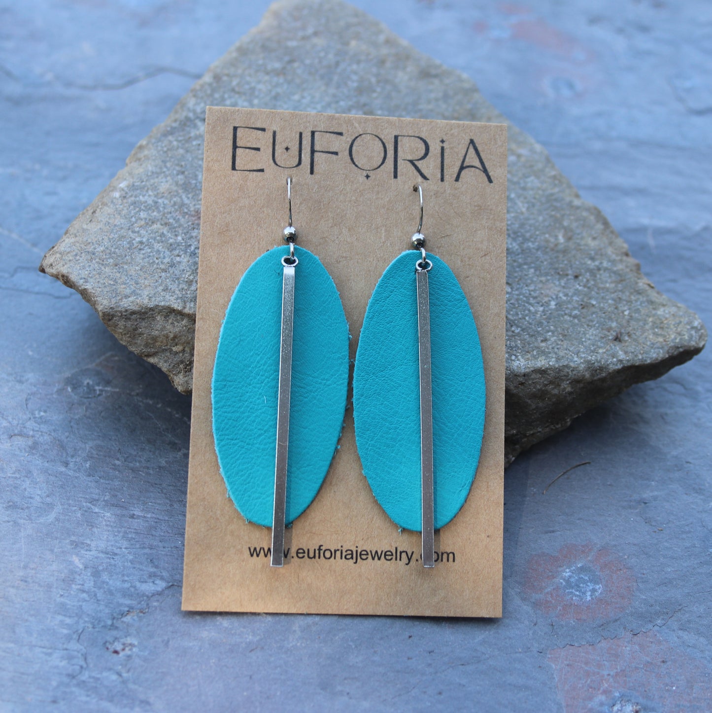 2" aqua leather oval with 2.25" stainless steel bar charm on stainless ear wires earrings.