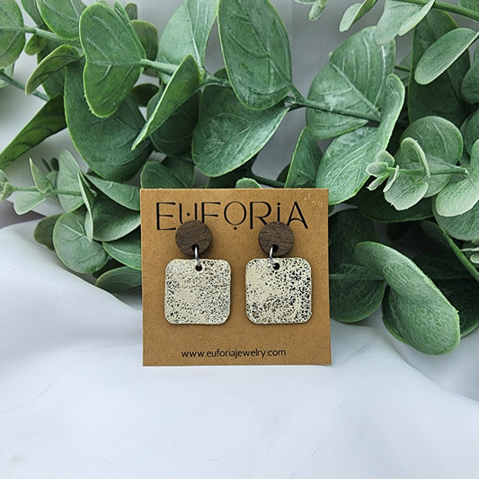 Leather square earrings with round wood post. .75" squares in metallic gold crackle over cream.