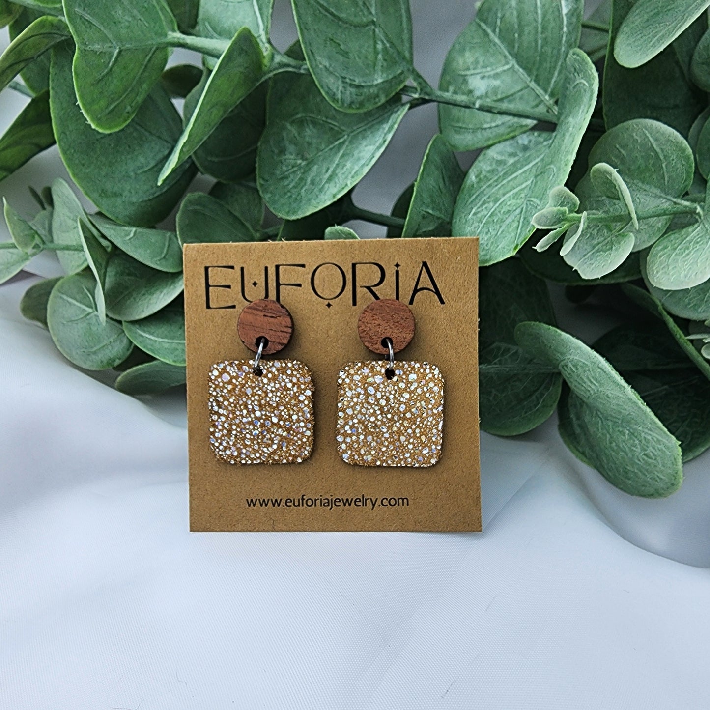 leather square earrings with round wood post. .75" squares with tiny holographic dots over tan.