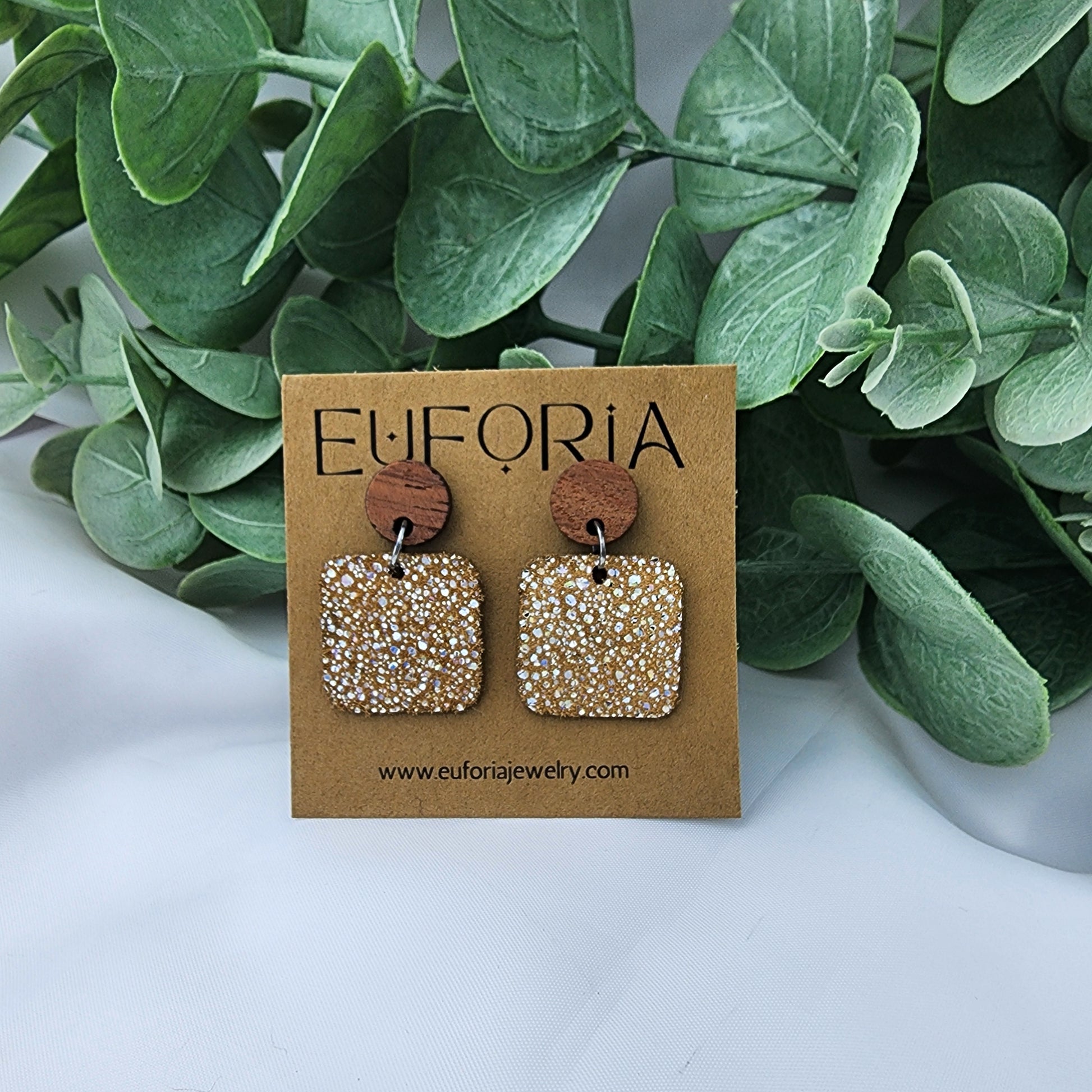 leather square earrings with round wood post. .75" squares with tiny holographic dots over tan.