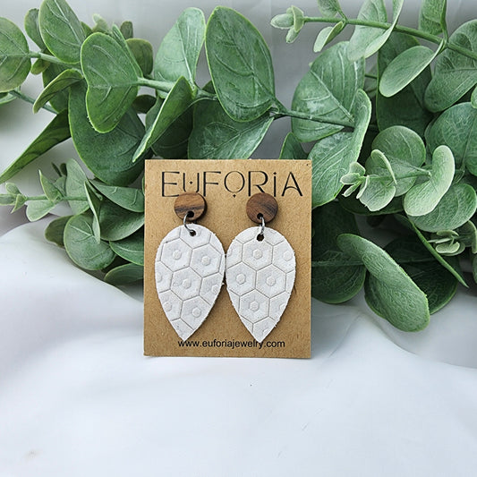 Leather teardrop earrings with round wood post. White with beehive texture.