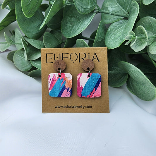 Cork over leather square earrings with round wood post. .75" squares in bold bright brushstrokes in blue, pink, coral and white.
