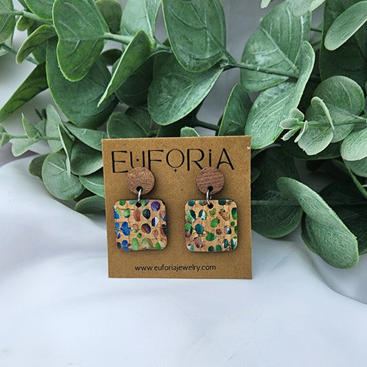 Cork over leather square earrings with round wood post. .75" squares with watercolor like primary colors and white dots over natural cork.