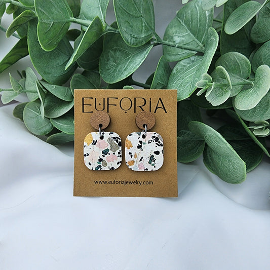 Cork over leather square earrings with round wood post. .75" squares with a mutli color terrazzo tile pattern over white.