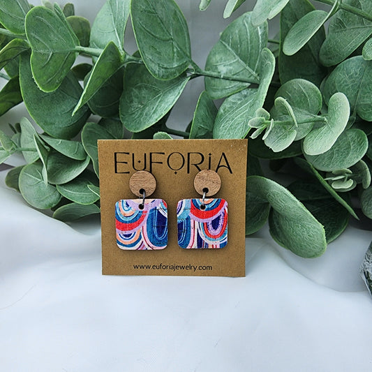 Cork over leather square earrings with round wood post. .75" squares of multi-color upside down arches in blue, pink, coral and white.