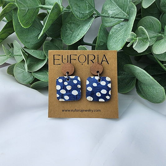 Cork over leather square earrings with round wood post. .75" squares rustic white dots over a blue field.