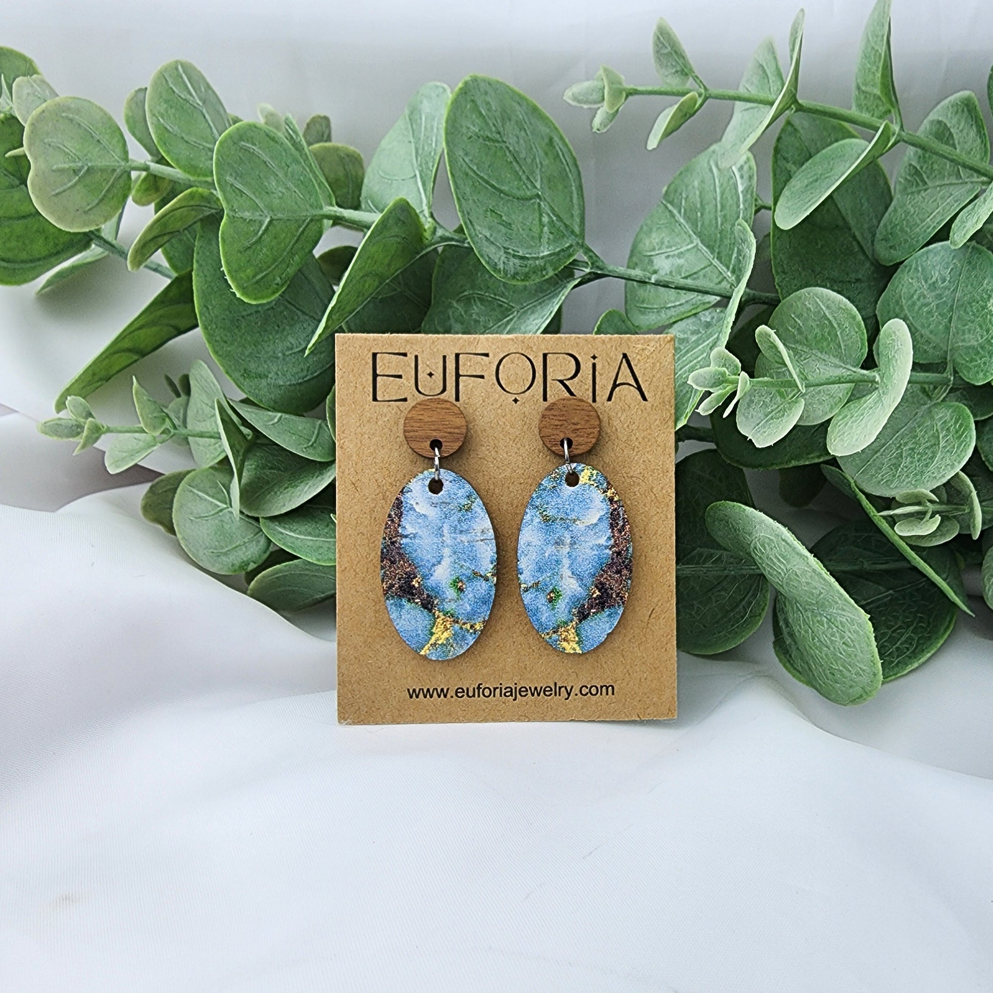 cork over leather oval earrings with round wood post.  1.25" ovals in a blue marbled stone print..