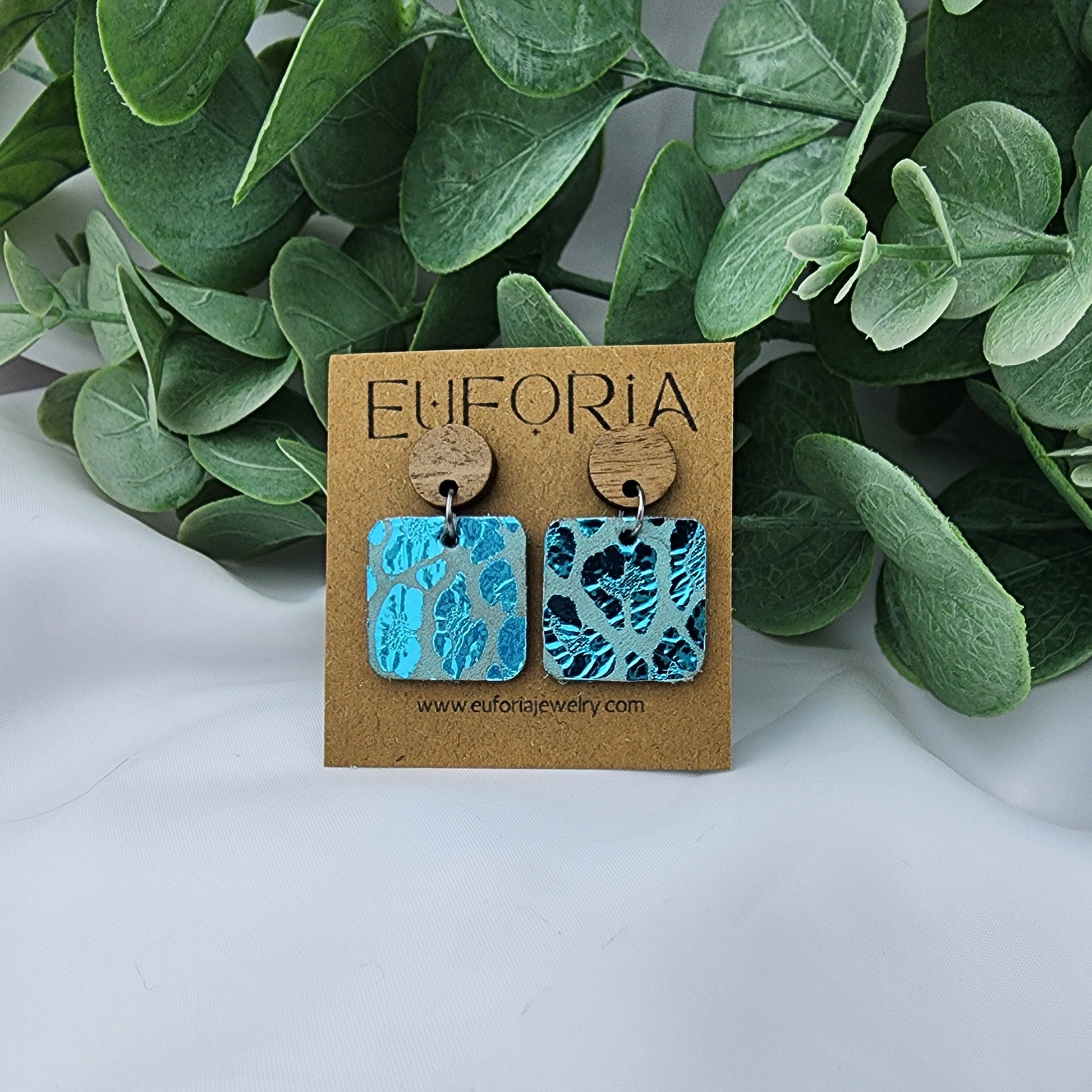 leather square earrings with round wood post. .75" squares in aqua metallic leopard print.