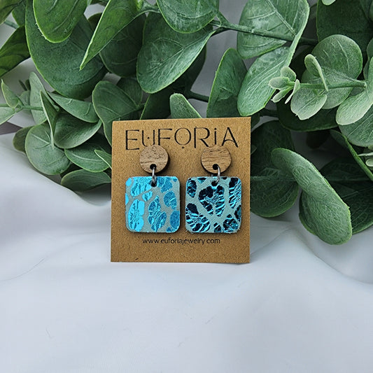 leather square earrings with round wood post. .75" squares in aqua metallic leopard print.