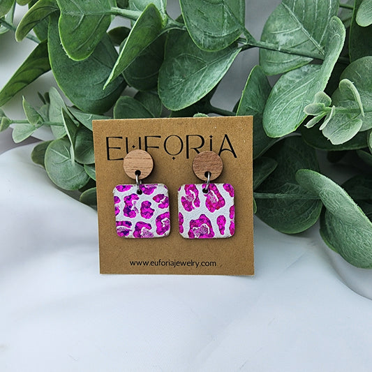 leather square earrings with round wood post. .75" squares in hot pink metallic holographic leopard print over white.