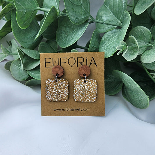 leather square earrings with round wood post. .75" squares with tiny holographic dots over tan.