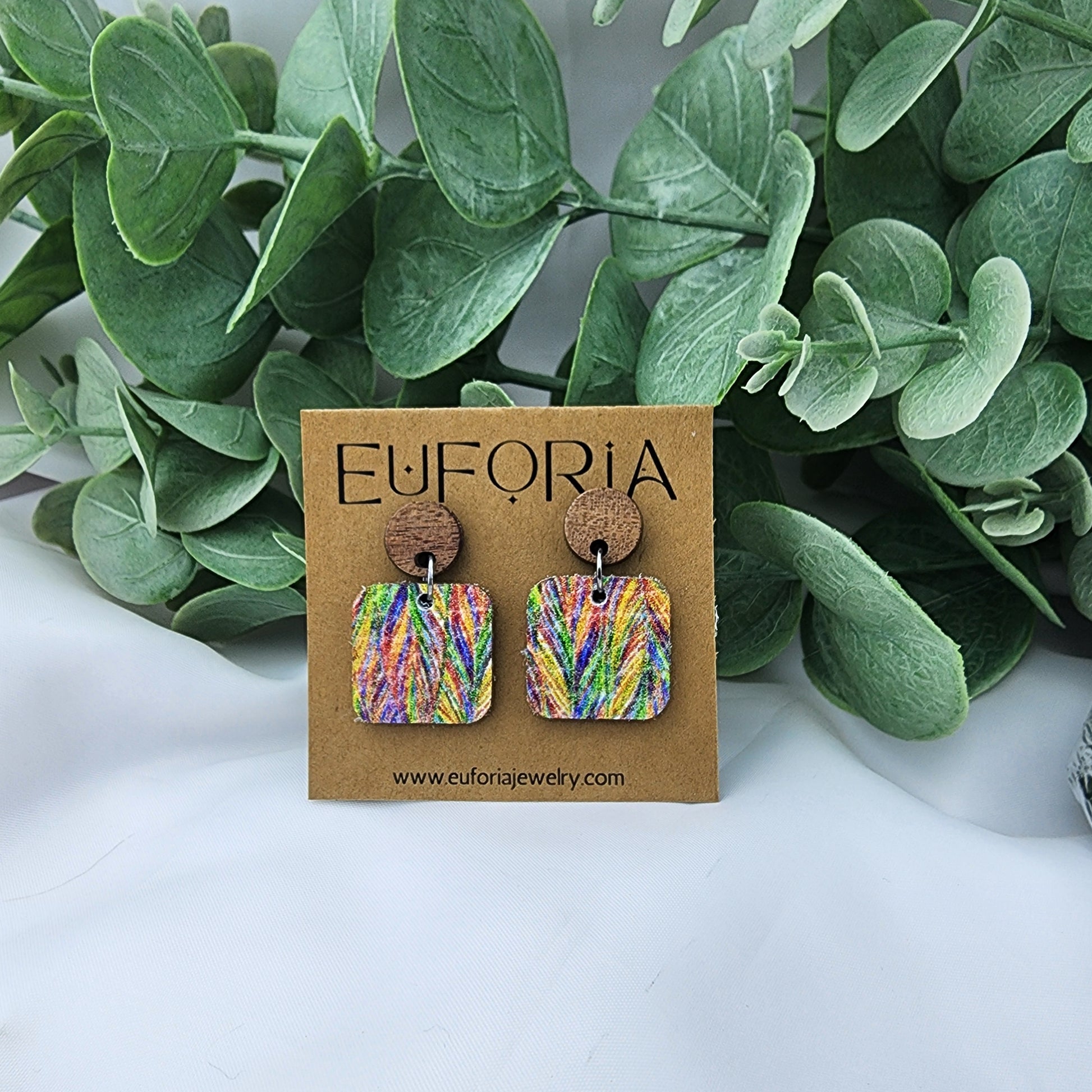 leather square earrings with round wood post. .75" squares in multi color feathers pattern.