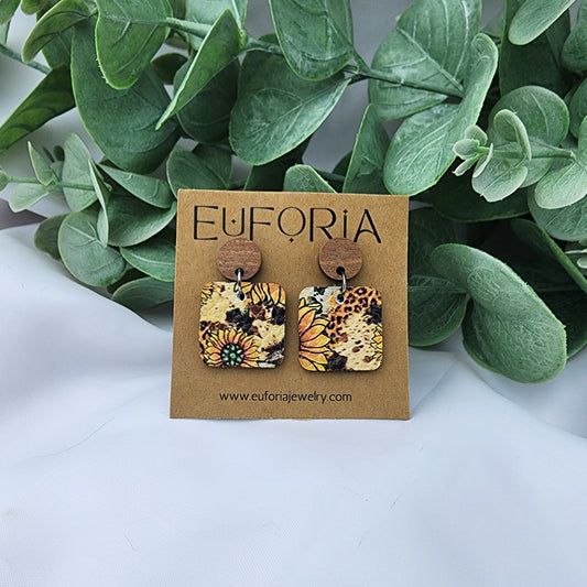 leather square earrings with round wood post. .75" squares in summery sunflowers over a mini leopard print field.