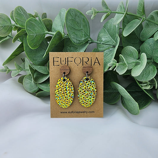 leather oval earrings with round wood post. 1.25" ovals with greeny-gold iridescent bumpy texture.