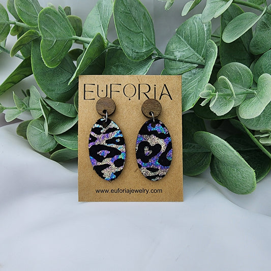 leather oval earrings with round wood post. 1.25" ovals with oil slick finish leopard print over black