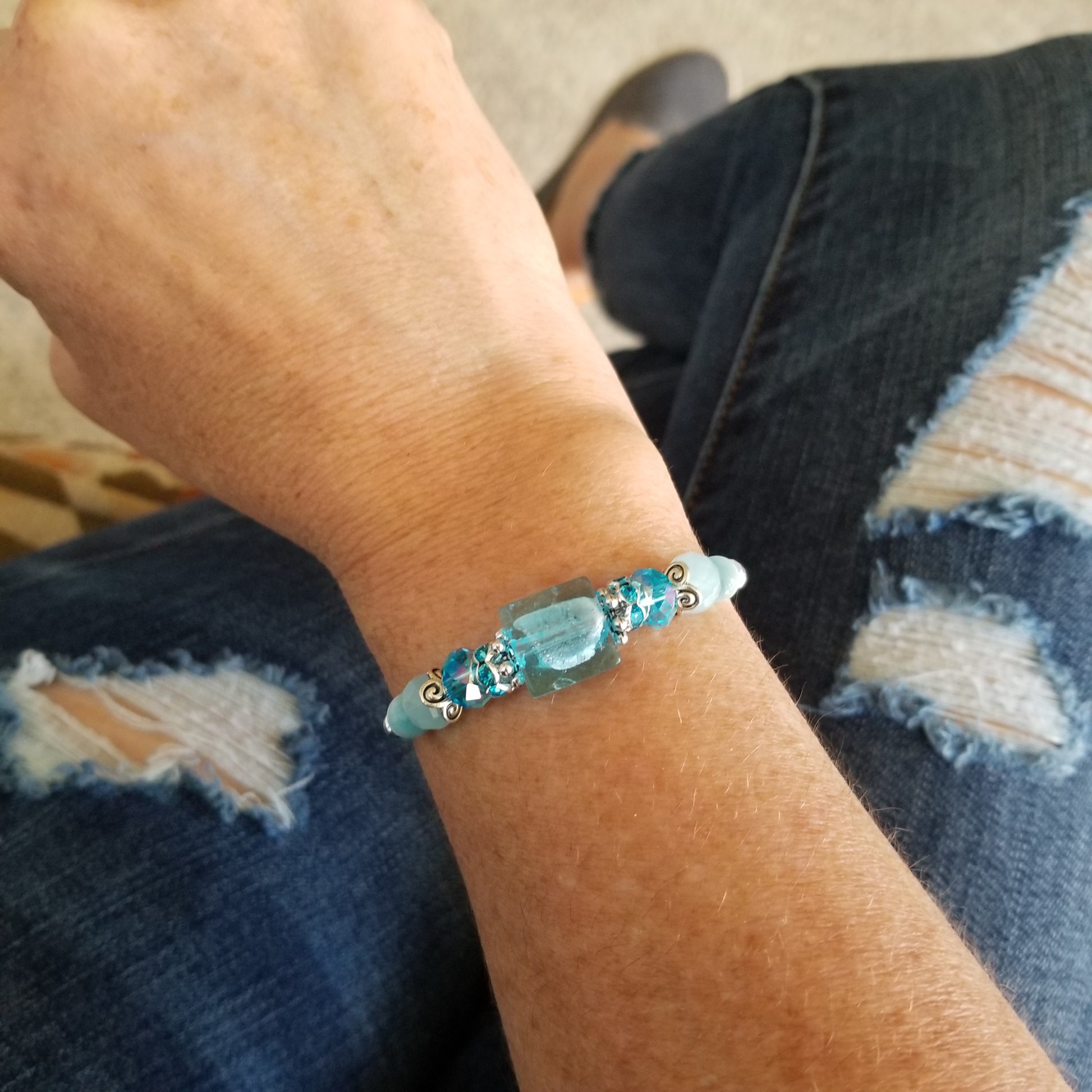 Aqua colored glass beads wrap bracelet on wrist