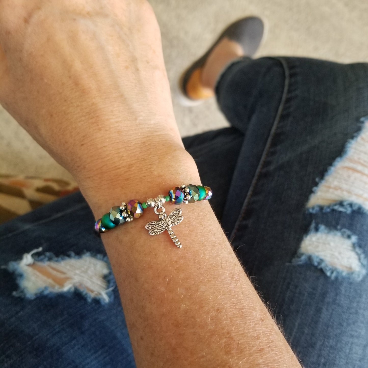 dragonfly charm and iridescent glass beads wrap bracelet on wrist