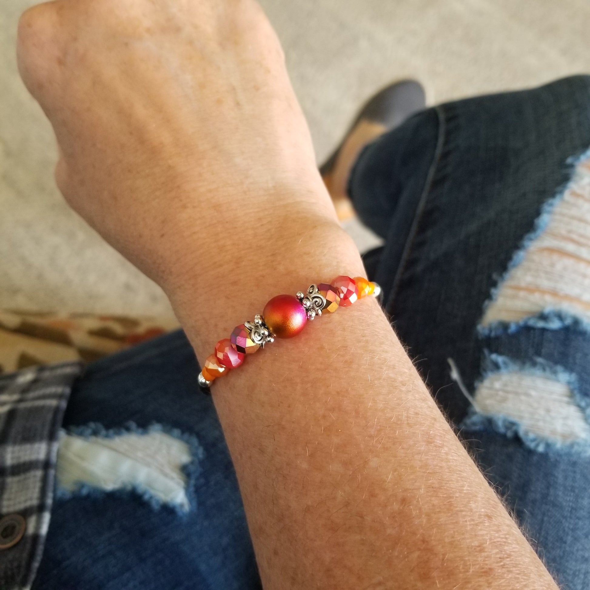 Iridescent Fire Orange glass bead with coordinating glass beads wrap bracelet on wrist