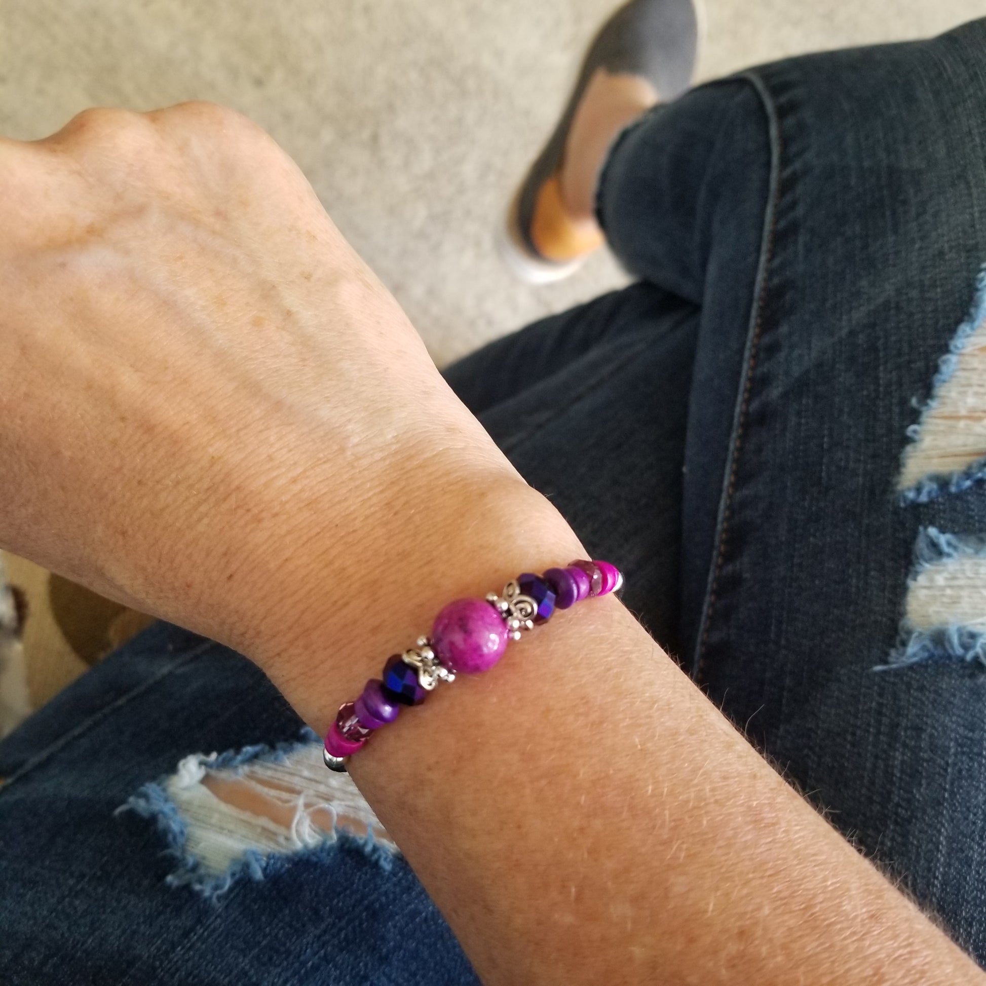 plum Riverstone with coordinating beads wrap bracelet on wrist