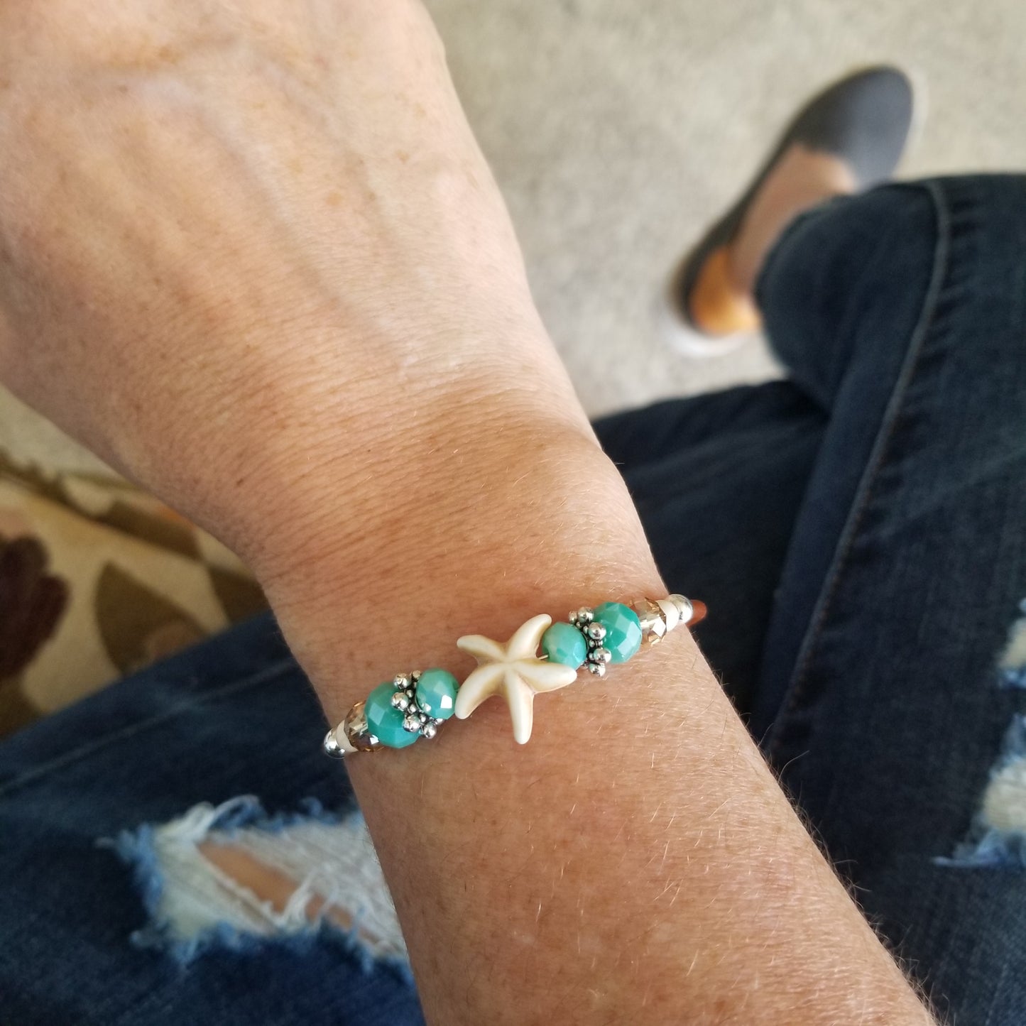 bone white starfish charm wrap bracelet on wrist