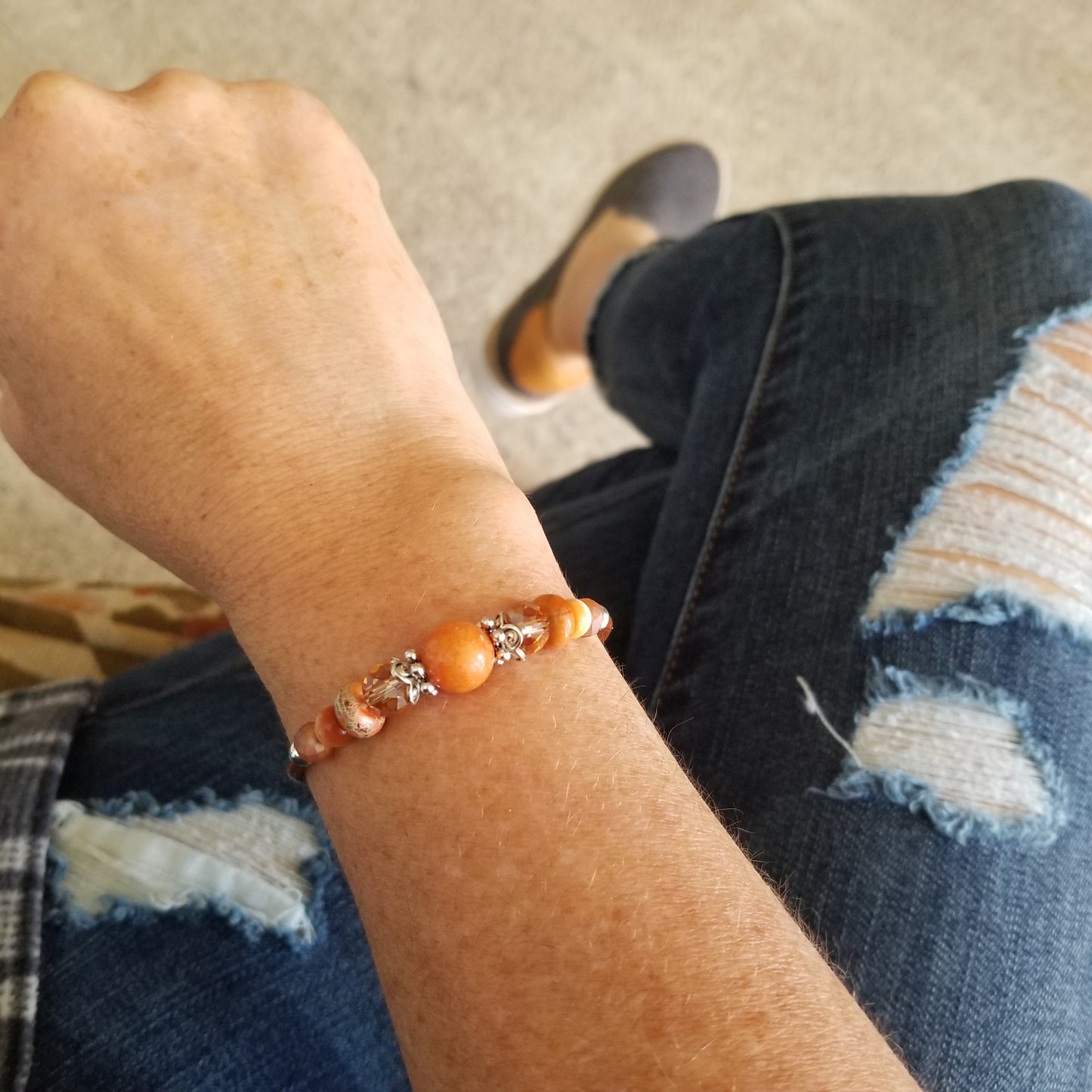 burnt orange riverstone with coordinating glass beads wrap bracelet on wrist