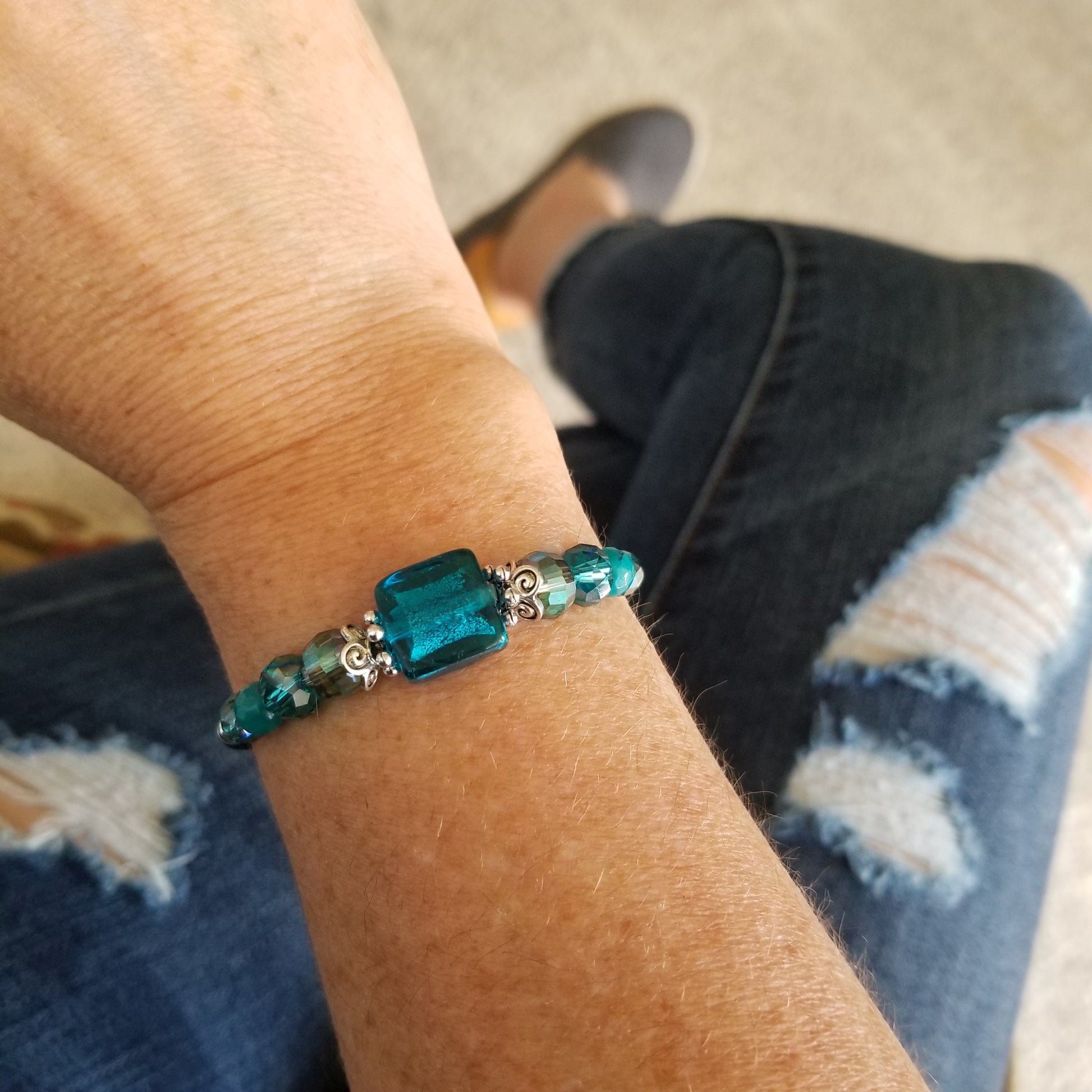 teal foil glass with coordinating beads wrap bracelet on wrist