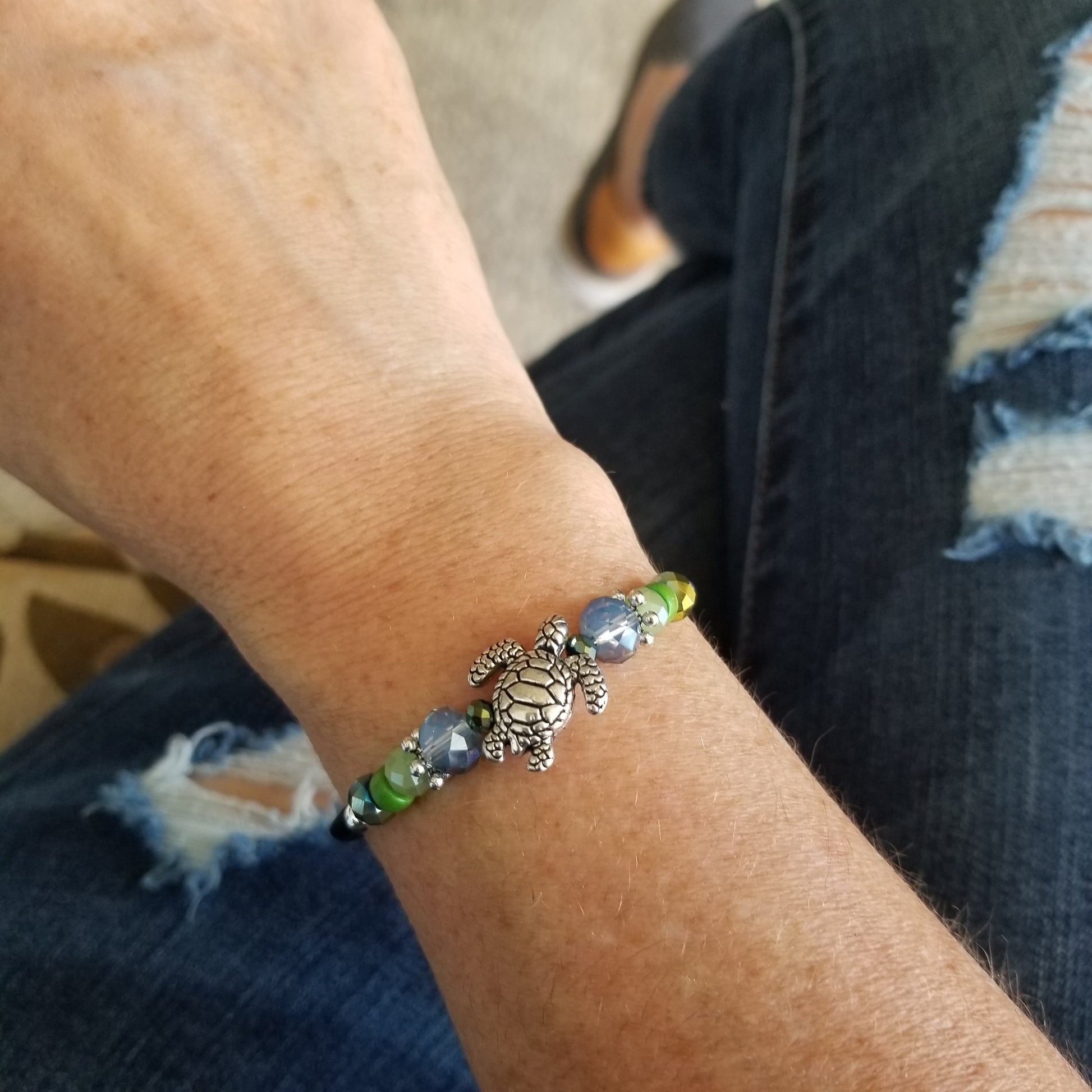 silver sea turtle charm and coordinating theme beads wrap bracelet on wrist
