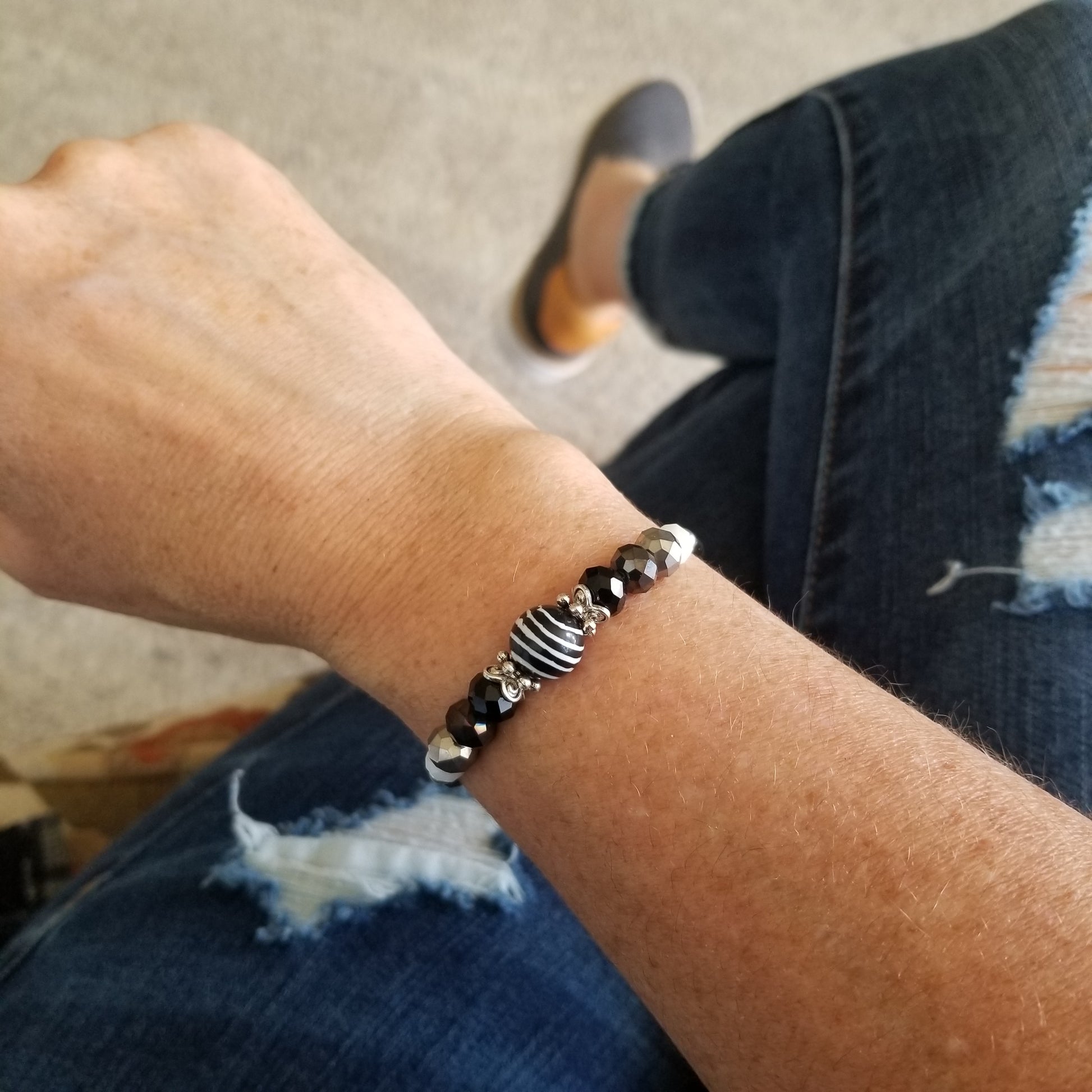 black and white striped bead with coordinating glass beads wrap bracelet on wrist